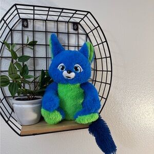 Blue and green fuzzy fox plushie